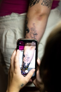 a woman is sitting in front of a mirror