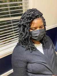 a woman wearing a face mask in front of a mirror