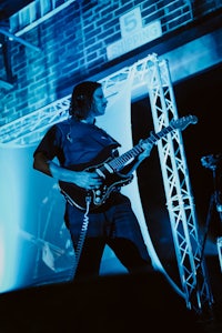 a man playing a guitar on stage