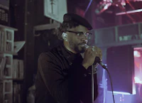 a man is singing into a microphone