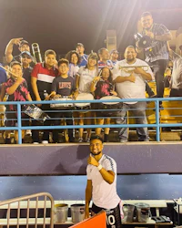 a group of people posing for a photo at a soccer game