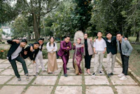 a group of people posing for a photo in a park
