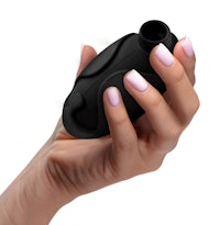 a woman's hand holding a black sex toy