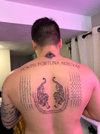 a man with a tattoo on his back