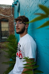 a man leaning against a wall