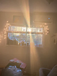 the sun is shining through a window in a living room