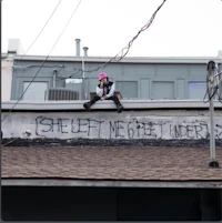 a person sitting on the roof of a building