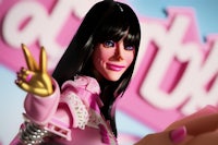 katy perry's barbie doll is posing in front of a pink sign