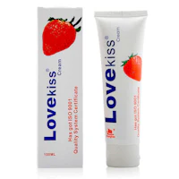 a tube of love kiss strawberry cream next to a box