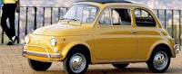 a yellow fiat 500 is parked on a brick walkway