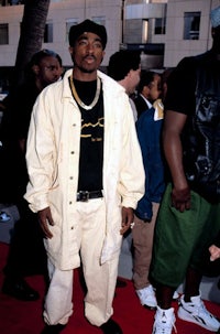 a man standing on a red carpet with other people