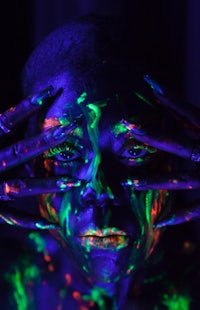a woman with glow in the dark paint on her face
