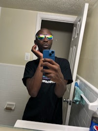 a man is taking a selfie in a bathroom