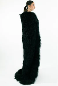 a woman wearing a black sheepskin shawl