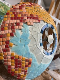a mosaic lamp is being made on a table