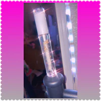 a clear tube of lipstick sitting on top of a mirror