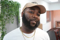 a man with a beard and a hat in an office