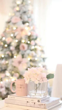 a table with books and a christmas tree in front of it