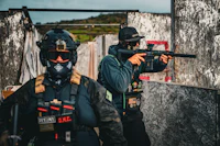 a paintball team in a building with a gun