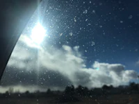 the sun shines through the windshield of a car