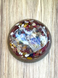 a colorful stone sphere on a wooden table