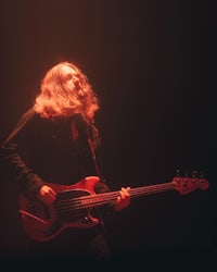 a man playing a bass in a dark room