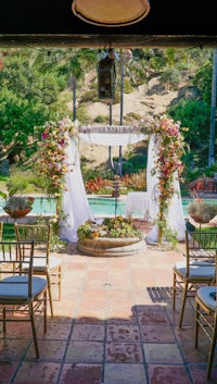 an outdoor ceremony set up with chairs and flowers