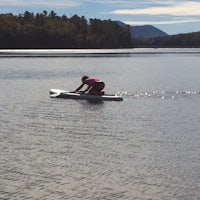 a person on a paddle board in a body of water