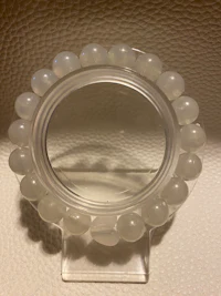 a clear plastic ring with beads on it