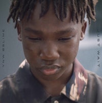a young boy with dreadlocks looking at the camera