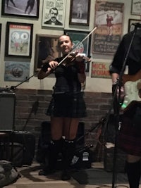 a man and a woman playing music in a pub