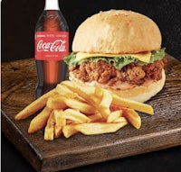 a chicken burger with fries and a coca cola bottle