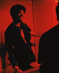 a man standing in front of a mirror with a smile on his face