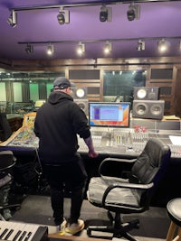 a man standing in a recording studio