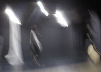 a blurry image of a dancer in a dark room