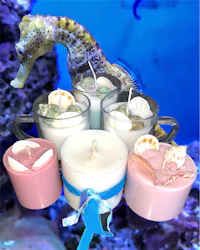 a seahorse is sitting on a candle holder