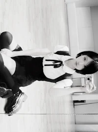 a girl in a black and white photo taking a selfie