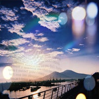 a photo of a bridge with a boat in the background