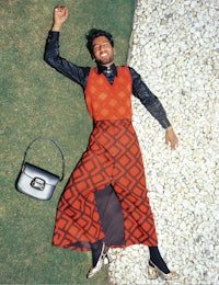 a woman laying on the ground with a purse