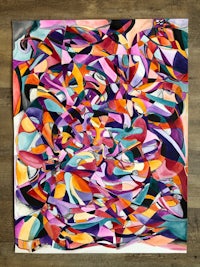 a colorful abstract painting on a wooden table