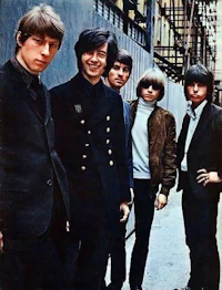 a group of young men posing in front of a building