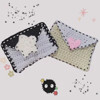 two crocheted pouches with stars on them