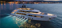 a white motor yacht in the water at night