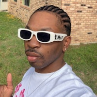 a man wearing white sunglasses and a white t - shirt