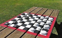 a picnic table with a chess set on it