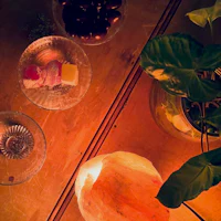 a table with a candle, bowls of food, and a plant