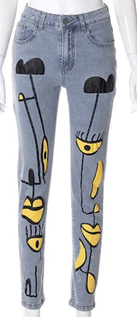 a mannequin wearing a pair of blue jeans with yellow eyes on them