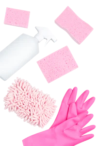 a pink cleaning kit with gloves and sponges on a black background