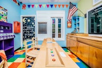 a colorful classroom with a table and chairs