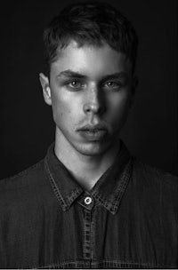a black and white photo of a young man